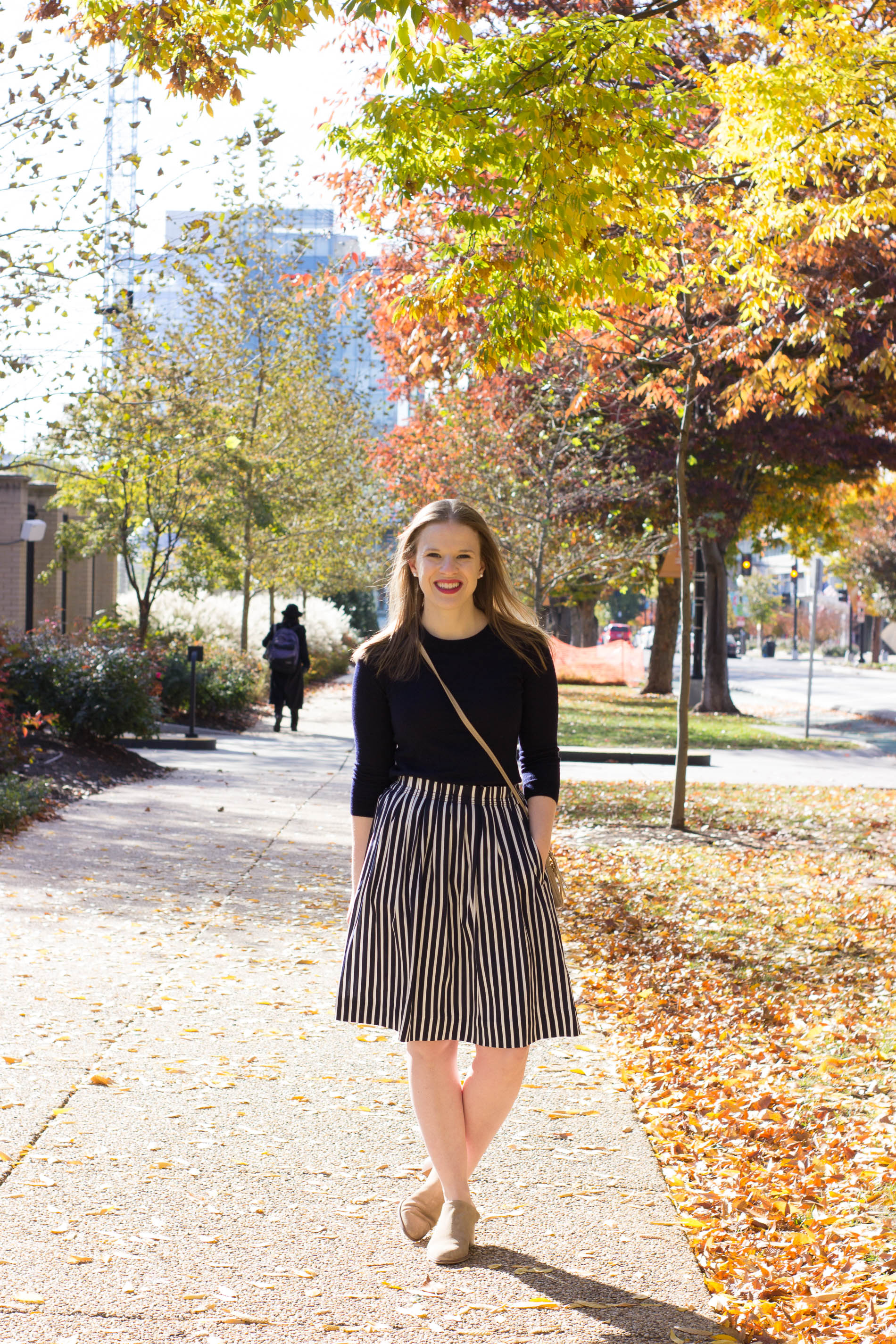 woman blogger wearing navy crew neck sweater and J.Crew striped midi skirt woman blogger wearing navy crew neck sweater and J.Crew striped midi skirt