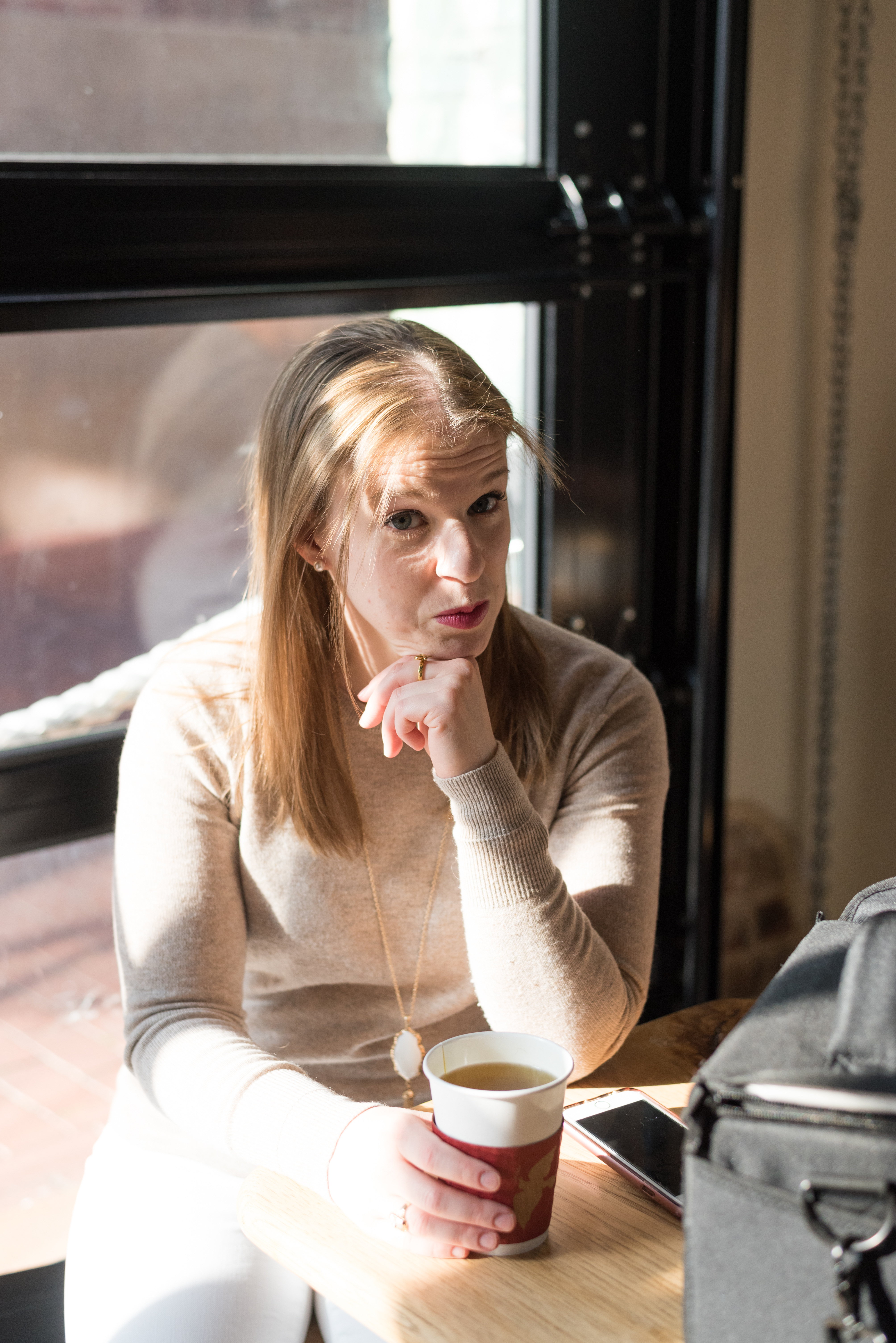 woman making funny face in coffee shop