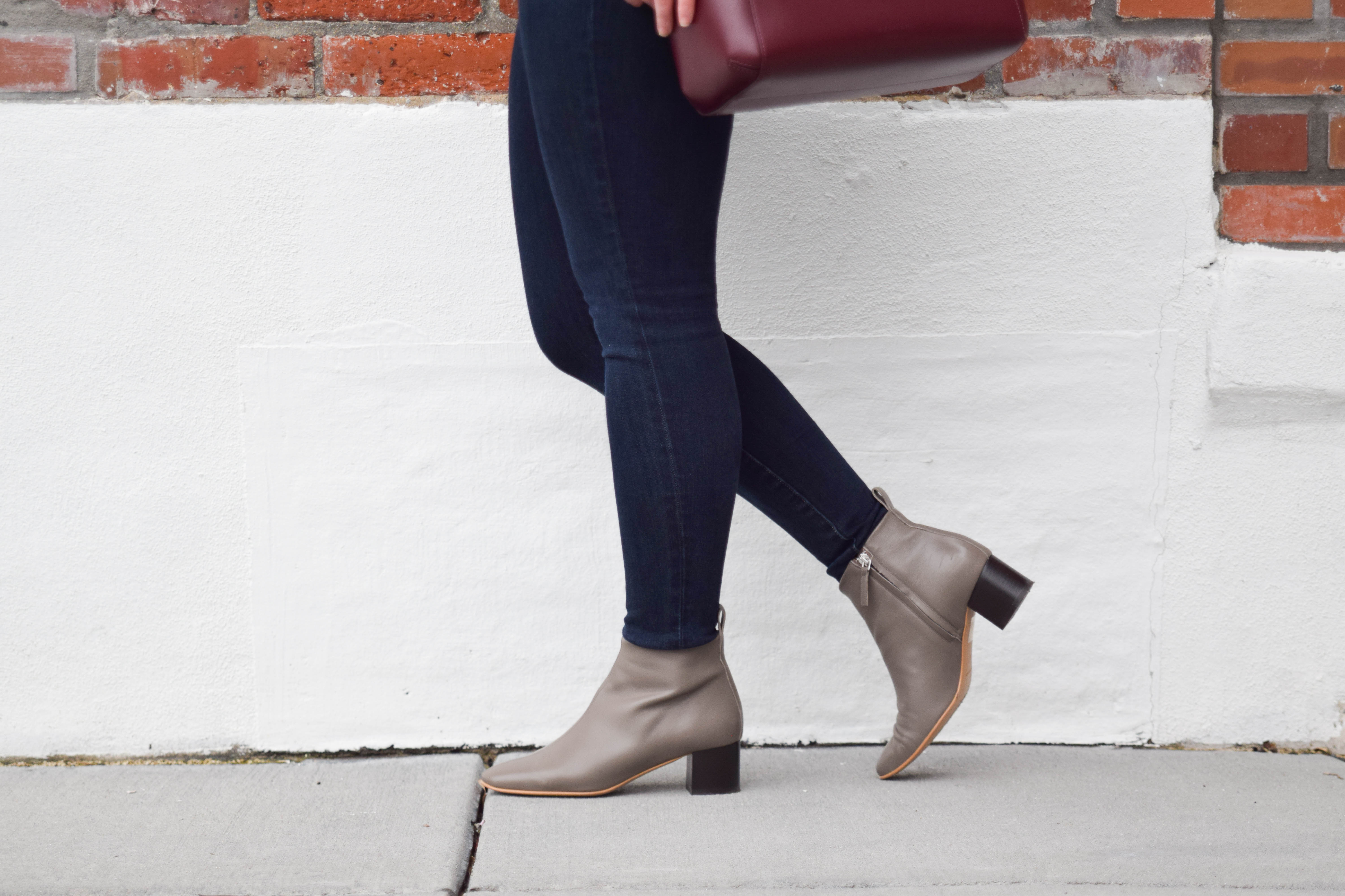 Dana Weinstein is wearing jeans and booties