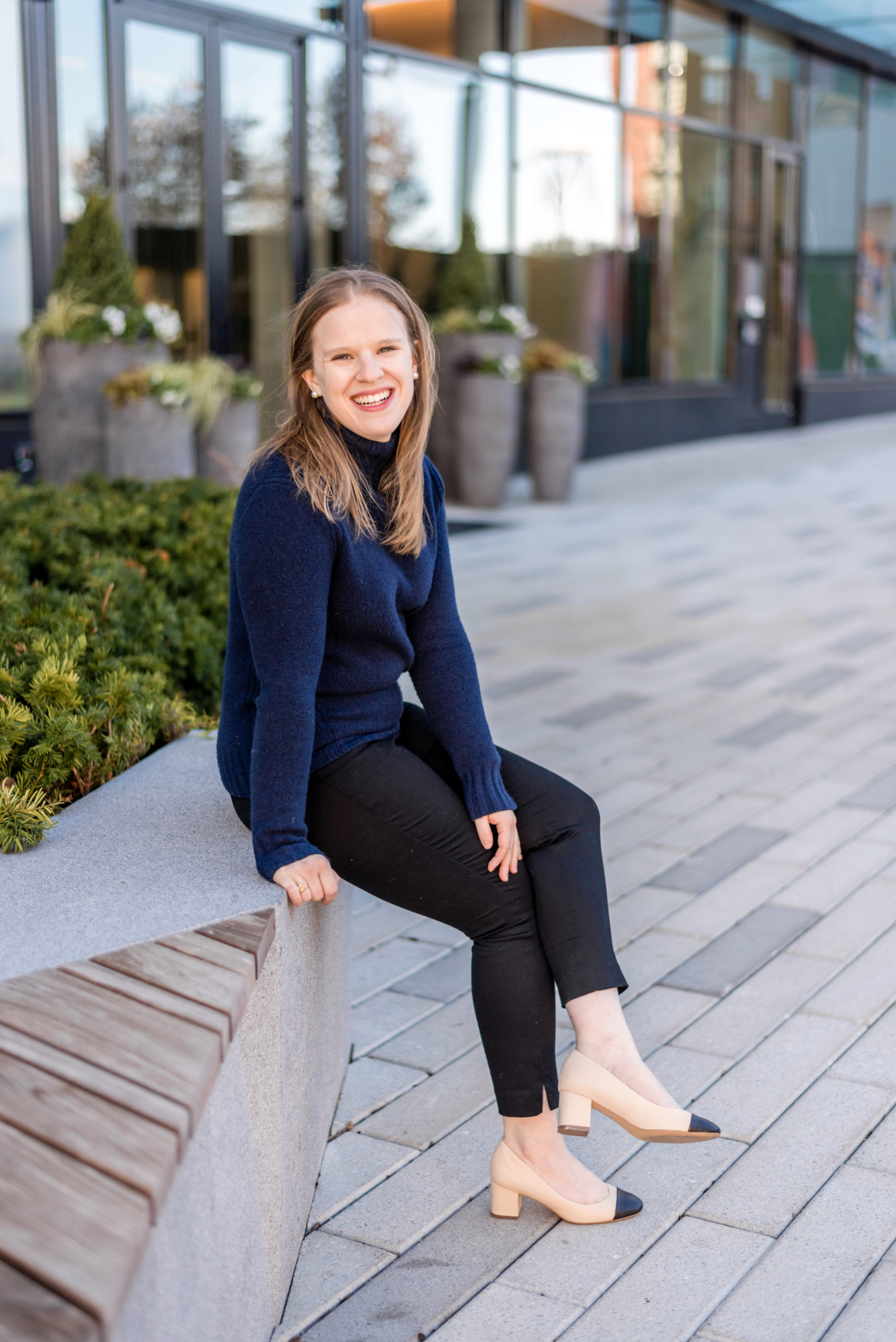 woman blogger wearing navy turtleneck sweater and heels woman blogger wearing navy turtleneck sweater and heels