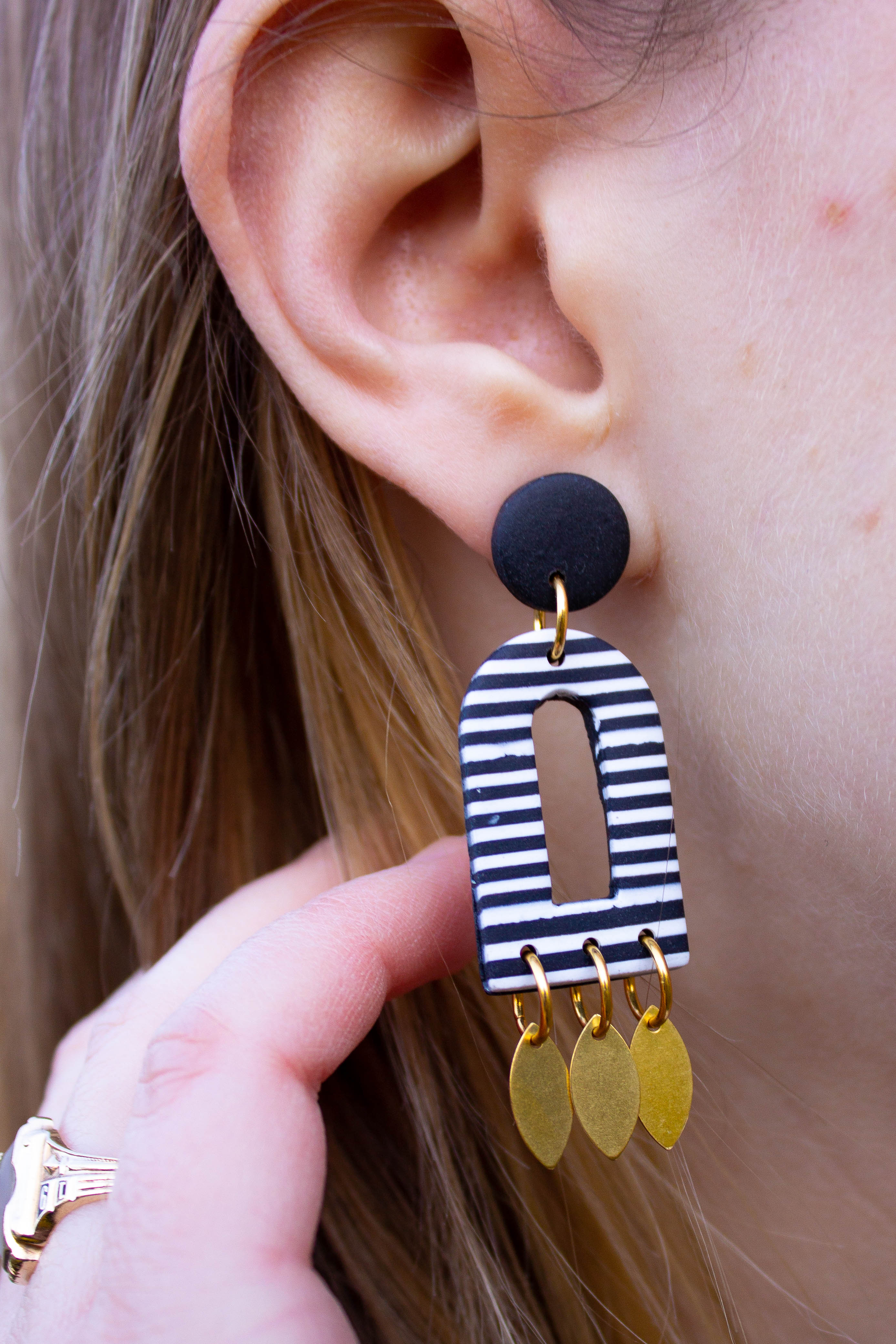 Emylee Williams striped dangling earring closeup of Emylee Williams striped dangling earring