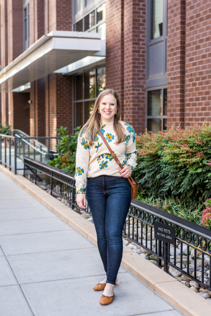 woman wearing floral sweater for Cute Thanksgiving Outfit Ideas woman wearing floral sweater for Cute Thanksgiving Outfit Ideas