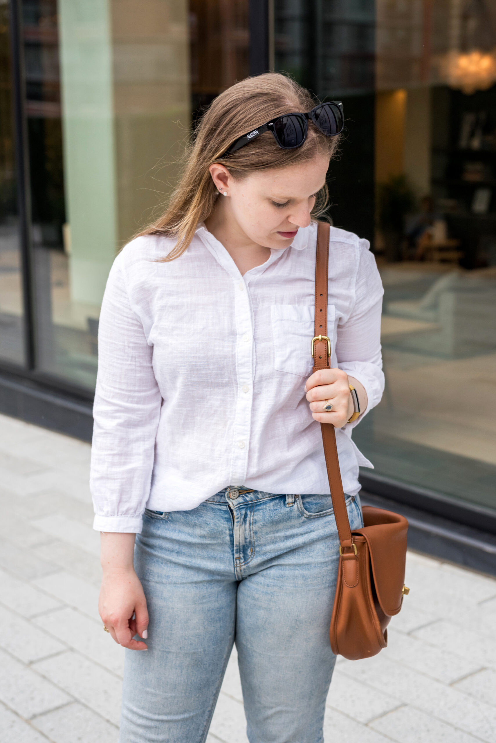 woman wearing White button up and crossbody bag woman wearing White button up and crossbody bag
